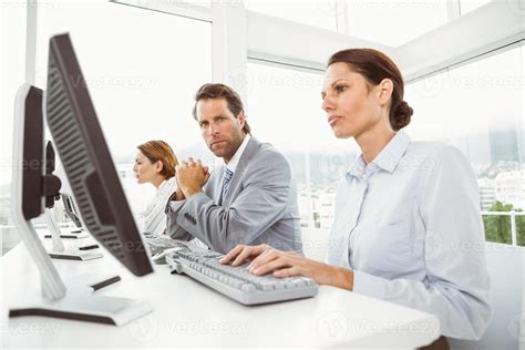 Business people using computers in office 905667 Stock Photo at Vecteezy
