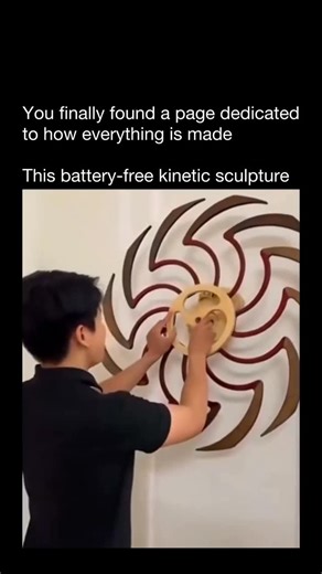 How Everything Is Made on Instagram: "This battery-free kinetic sculpture works on stored mechanical energy. With just a single twist, a hidden spring winds up — and as it slowly unwinds, it releases that energy into a series of precision-cut Eucalyptus and Ash plywood blades. Each blade is angled and spaced to create a continuous wave-like motion, so the energy transfers smoothly down the mechanism for up to 15 minutes of movement. There’s no motor, no battery — just clever engineering, frictio