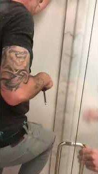 How to adjust sagging frameless door that’s hitting glass panel.