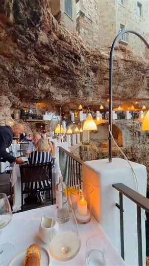 Wonders on Instagram: "Polignano a Mare, Italy 🇮🇹 A beautiful escape where limestone caves meet the clear blue waters of the Adriatic Sea. This famous cliffside restaurant sits inside a natural cave shaped by waves over thousands of years, and special gatherings have taken place here since the 1700s. Its warm lights and fresh local dishes create a place full of charm and calm. A destination of timeless beauty and wonder! Who would you visit with?🍝 #Wonders video by @k80hall"