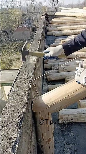 The art of roofing! Wooden beam installation done in one step.