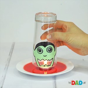 This Halloween, add a vampire twist to a classic science experiment! 🧛‍♂️✨ Watch in awe as a “vampire” sucks up all the blood (colored water) when the candle goes out under the glass. 🩸🕯️ Your little scientists will be amazed by this simple, yet spooky, science activity perfect for the Halloween season! | TheDadLab