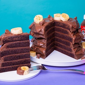 322K views · 4.1K reactions | Chocolate, chocolate, and more chocolate! To make our Nutella pancakes cake, we stacked layers of chocolate cake covered in chocolate ganache with loads of nutella 襤! We topped the stack off with vanilla fondant 'bananas' and classic Hershey kisses. | How To Cake It | Facebook
