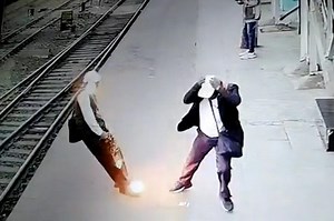 Shocking moment man is zapped by falling power line on train platform