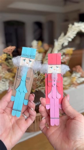 Sarah Pope on Instagram: "Save this idea for a craft night! 🩷🩵🤎🤍 DIY popsicle stick nutcrackers. If you want a link to all the paint colors I used comment NUTCRACKER and I will send a dm to you! I will also have everything linked in my LTK as well in my bio. Below are the directions! 👇🏼👇🏼 Step 1. Set 2 craft sticks aside for the legs of the nutcracker. Then, cut 3 craft sticks in half. Three havles will be used for the torso of the nutcracker. Step 2. Carefully cut off a third of 5 popsi