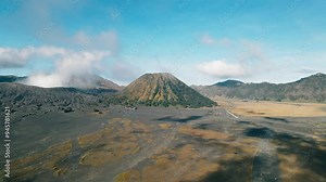landscape view of Mount Bromo desert from drone with moving clouds, clear sky, Indonesia