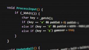 Video of program code scrolling across black computer monitor screen