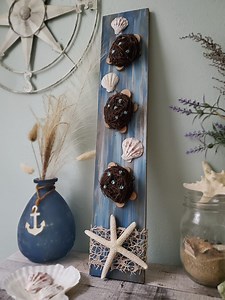 Let's make a rustic beach sign with little sea turtles using mini faux bird nests and mini wood slices! I think this turned out so cute 💙 I hope you enjoy! #coastalvibes #beachdecor #rusticdecor #seaturtleart #seaturtles #oceandecor #beachvibes #starfish #rustichomedecor #coastaldecor #handmadesigns | Love Crafted Decor
